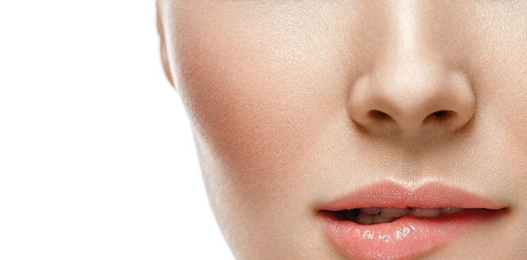 Woman face lips and nose studio white background