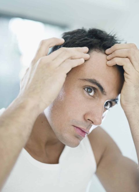 Young Handsome Man Checking Receding Hairline